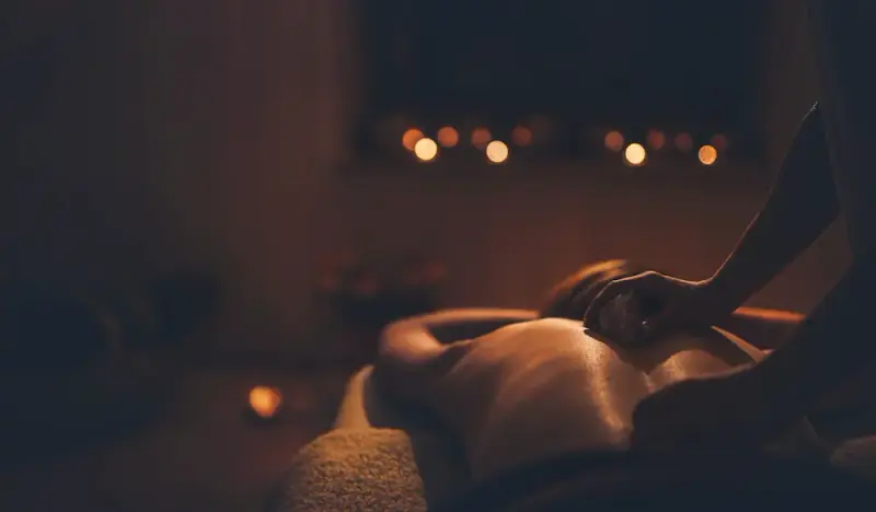 Luxury erotic massage with candlelight ambiance and sensual touch