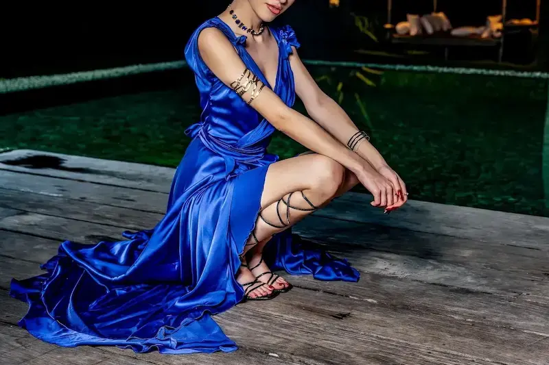 High-class Vienna escort in a blue satin evening gown dressed for an evening at the opera