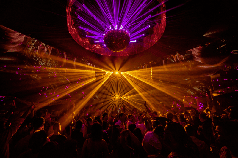 Ibiza closing party nightclub with disco ball and light show