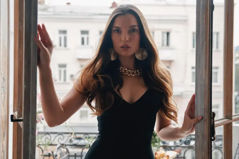 Elegant high-class escort companion on a balcony in Brussels