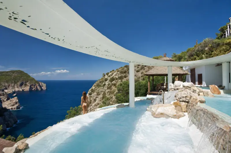 Luxury boutique hotel pool in Ibiza overlooking the Mediterranean cliffs and sea